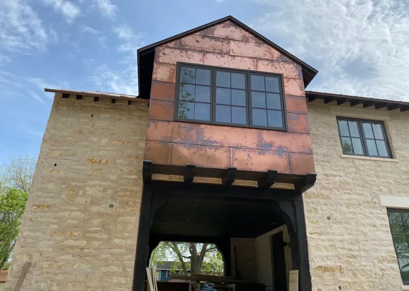 Copper metal panel facade on a stone building for Skylight Installation in East San Gabriel