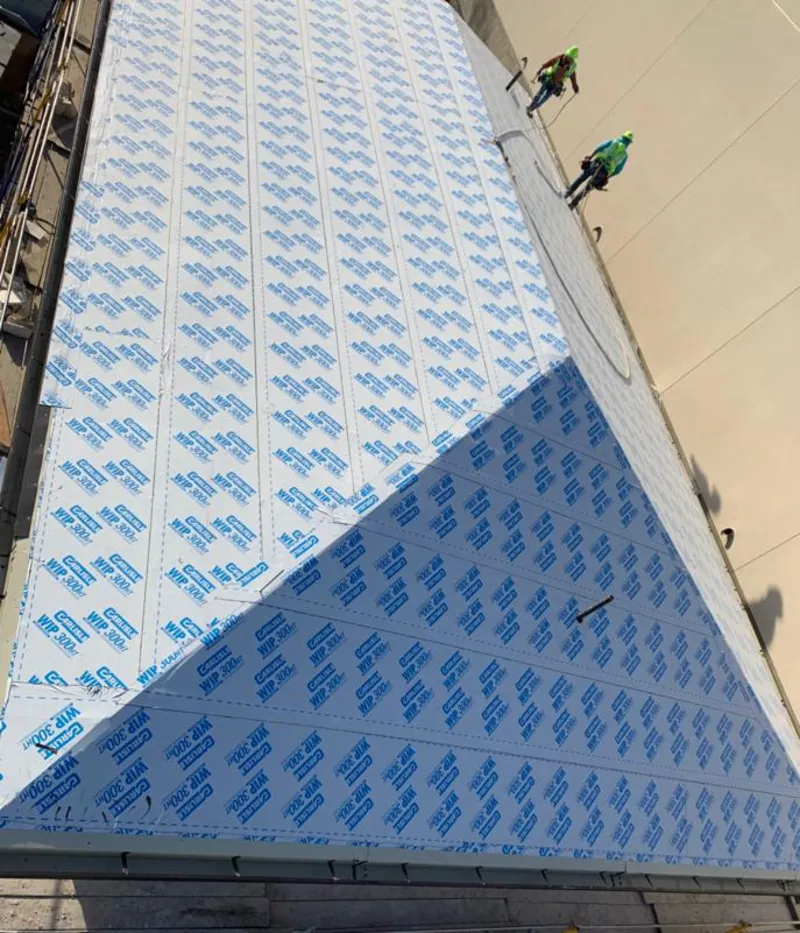 Professional roofers installing underlayment on a metal roof in East San Gabriel